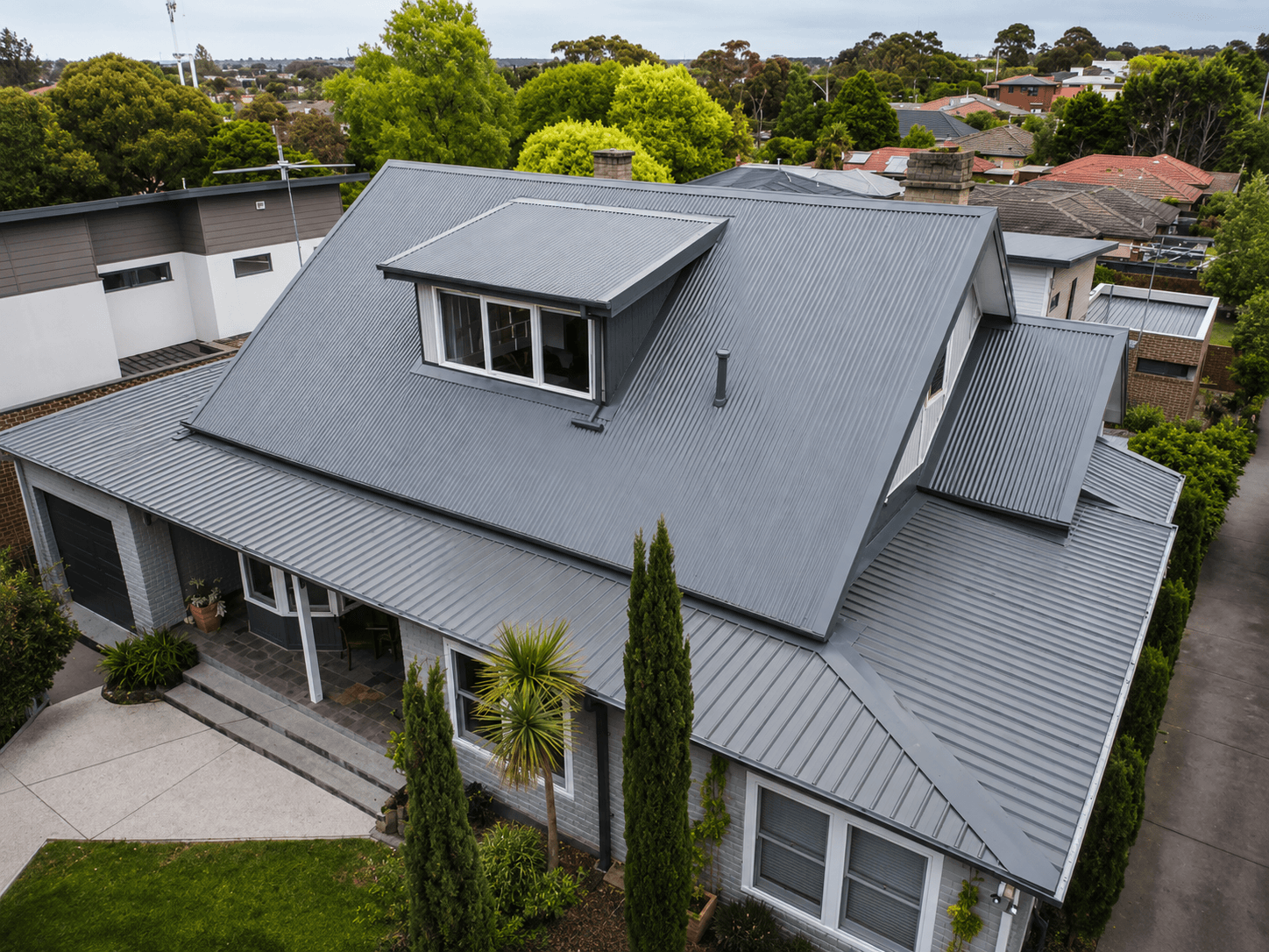 Aerial view of a restored grey COLORBOND tile roof by Sandhurst Roofing